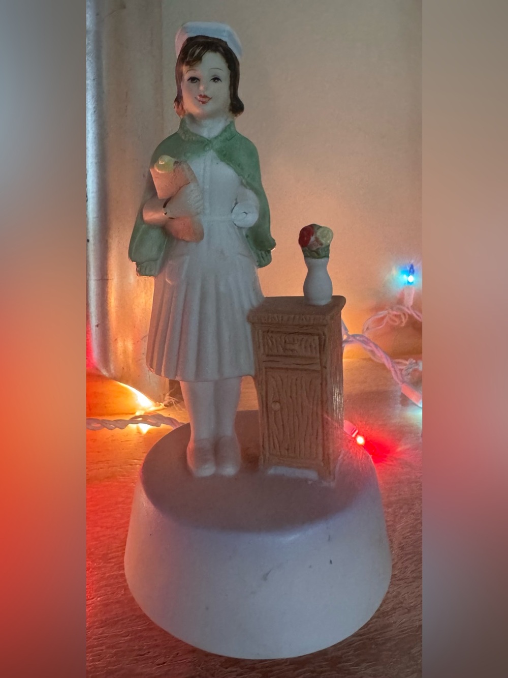 Vintage porcelain nurse rotating music box